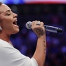 Demi Lovato sings the national anthem before a super welterweight boxing match between Floyd Mayweather Jr. and Conor McGregor