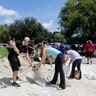 City of Miami volunteers help residents fill free sandbags in Miami, Thursday