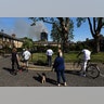 People look at smoke billowing from the apartment tower on fire, in West London