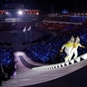 North Korea's Jong Su Hyon and South Korea's Park Jong-ah carry the Olympic torch during the opening ceremony in Pyeongchang