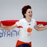 Gold medallist Jorien ter Mors of The Netherlands celebrates with the national flag after the women's 1,000 meters speedskating race