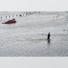A police officer wades through the Hurricane Harvey floodwaters in Alvin, Texas, Tuesday