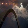 Multiple exposure photograph of the phases of a partial solar eclipse over the Gateway Arch in St. Louis