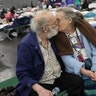 Don and Peg Sauter kiss as they take refuge from Tropical Storm Harvey at the George R. Brown Convention Center in Houston, Tuesday