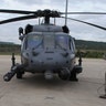 A crew chief watches aircrews of the 101st Rescue Squadron during HH-60 Pavehawk Helicopter pre-flight checks