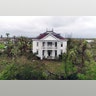 Debris lies on the ground outside the historic John H. Wood and Nancy Clark Wood House in Bayside, Texas, Monday