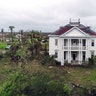 Debris lies on the ground outside the historic John H. Wood and Nancy Clark Wood House in Bayside, Texas, Monday