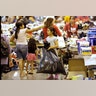 A Harvey flood evacuated child carries donated supplies in a bag at a shelter setup inside NRG Center, Wednesday, in Houston