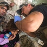 Sky Barkley treats a little girl during the push into Mosul, May 5, 2017