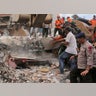 Rescuers recover the body of a victim from a collapsed building after an earthquake in Pidie Jaya, Aceh province, Indonesia.