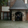 A man standing in the doorway of his flooded home responds to an evacuation offer in Houston, August 28, 2017