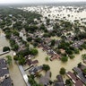 Water from Addicks Reservoir flows into neighborhoods as floodwaters from Tropical Storm Harvey rise Tuesday, in Houston