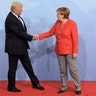 President Donald Trump is welcomed by German Chancellor Angela Merkel on the first day of the G-20 summit in Hamburg, Germany