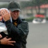 Sgt. Chad Watts, of the Louisiana Department of Wildlife and Fisheries, holds Madelyn Nguyen, 2, after he rescued her in Houston, Monday