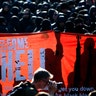 Protesters hold a placard during a demonstration at the G-20 summit in Hamburg, Germany