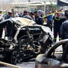 A wreckage of a car is seen at the site of car bomb attack in Baghdad