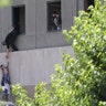 A boy is evacuated during an attack on the Iranian parliament in central Tehran, Iran