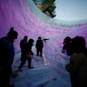 Artists and workers prepare an ice sculpture in China.