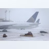 Snowplows work to keep the grounds clear at Newark Liberty International Airport in Newark, NJ.