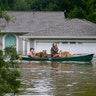 A family evacuates their Meyerland home in Houston, Texas, Sunday