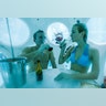 Belgians Florence Lutje Spelberg and Nicolas Mouchart drink champagne while sitting inside 