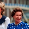 Britain's Diana, Princess of Wales, and Britain's Queen Elizabeth II smile to well-wishers outside Clarence House in London, August 4, 1987