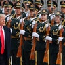 U.S. President Donald Trump reviews an honor guard during a welcome ceremony at the Great Hall of the People in Beijing, November 9
