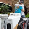 Barry Horvitz hugs his wife Kim after removing items damaged by floodwaters from Tropical Storm Harvey in Houston, Wednesday