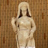 A limestone statue of a woman dressed with a cloak, found at Hatra