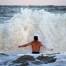 Body surfer Andrew Vanotteren crashes into waves from Hurricane Florence on the south beach of Tybee Island, Georgia, Wednesday