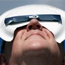 Tim Burt uses a paper pate to hold his solar eclipse viewing glasses in place in Hopkinsville, Kentucky