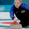 Nina Roth throws a stone during a women's curling match against Canada