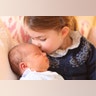 Britain's Princess Charlotte cuddles her brother Prince Louis, on her third birthday, at Kensington Palace, in London, May 2, 2018