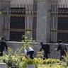 Members of Iranian forces run during an attack on the Iranian parliament