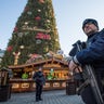 Police officers carrying machine guns patrol at the Christmas market in Dortmund, Germany, Tuesday Dec. 20, 2016. A truck ran into a crowded Christmas market in Berlin the evening before and killed several people.