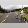 Leilani Estates resident Sam Knox watches the lava stretch across the road, in Pahoa, Hawaii, May 5, 2018, 