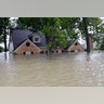 A home is surrounded by floodwaters from Tropical Storm Harvey, Monday, in Spring, Texas