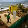  Roberto Figueroa Caballero sits on a small table in his home that was destroyed by Hurricane Maria in San Juan, Puerto Rico, October 5, 2017