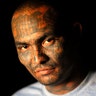 A member of the Mara Salvatrucha gang poses for a photograph at the prison of Ciudad 