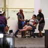 A wounded woman is moved outside the Tropicana during a shooting on the Las Vegas Strip, Sunday