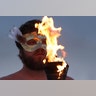 A participant takes part in a fire ceremony at the annual Burning Man arts and music festival, August 28