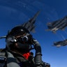 Two U.S. Air Force B-1B Lancers pass by a Republic of Korea air force F-15 jet over the Korean Peninsula, July 30