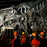 Rescuers work at the site of a collapsed building after an earthquake in Mexico City, Wednesday