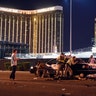 Las Vegas police stand guard along the streets outside the Route 91 Harvest Country music festival grounds, Sunday, in Las Vegas