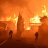 Firefighters work to put out a blaze burning homes early Tuesday in Ventura, California