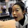 Xiao Huang of Zero Zero Robotics demonstrates the safety of the company's Hover Camera Passport drone by pretending to bite it during the 2017 CES in Las Vegas, Nevada.