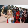 Attendees arrive dressed in costume for the opening day of Comic-Con International in San Diego