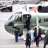 Former President Barack Obama waves from a helicopter as President Donald Trump walks with wife Melania Trump back to the Capitol Building in Washington.