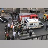 In this photo provided by Sheng Zihao, an unidentified wounded person is taken into an ambulance in Paris, Friday, Feb. 3, 2017. 