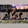  People run from the Route 91 Harvest country music festival during a shooting on Sunday evening in Las Vegas